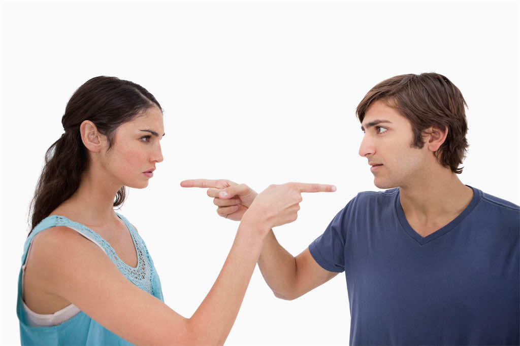 Couple mad at each other against a white background